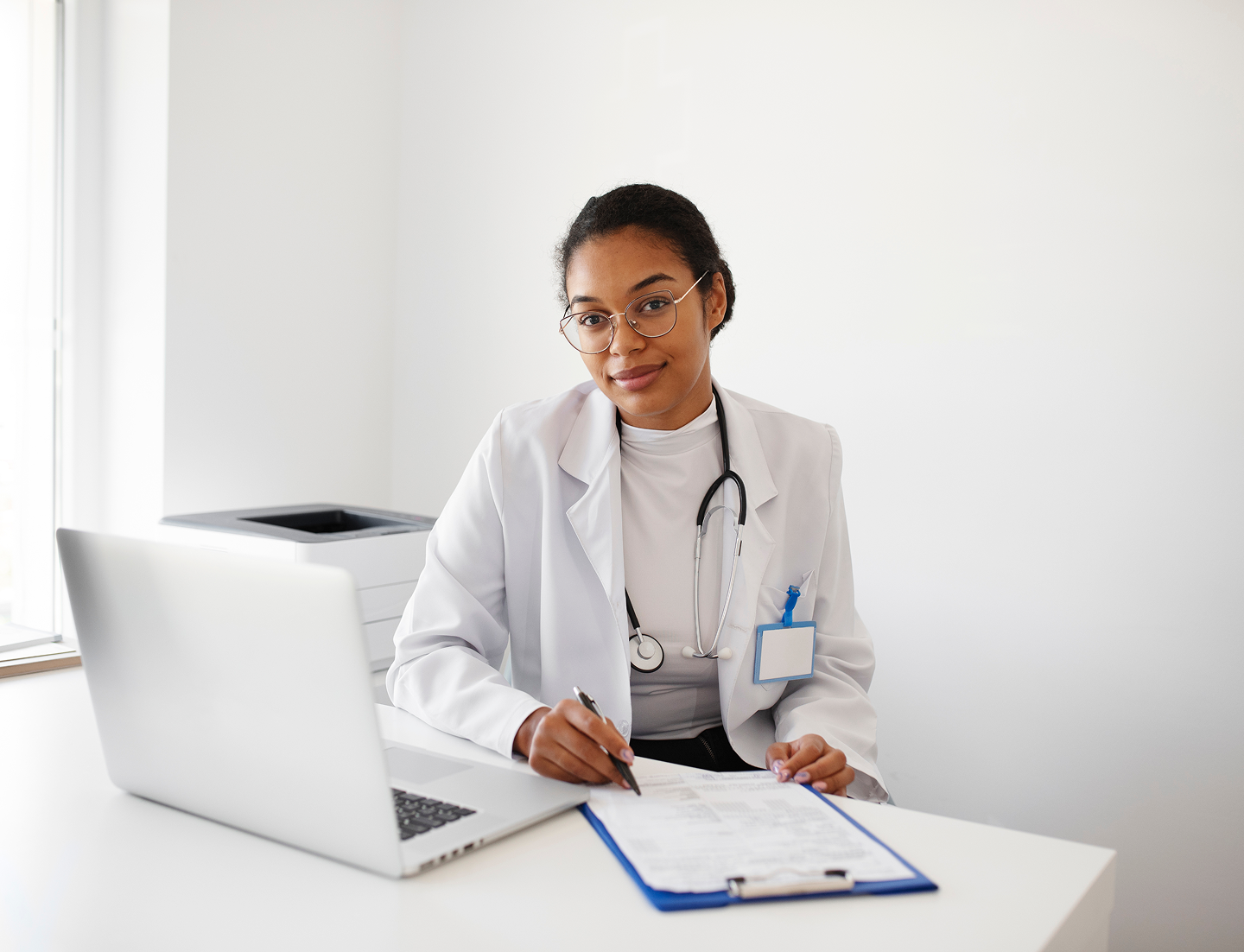 medium-shot-doctor-walking-with-laptop 1